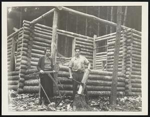 Families Start Log Cabin Community. Shown here are Mr. and Mrs. Bertram Smith working on a cabin estimated to cost $400 as they prepared to establish themselves with seven other families in a cooperative log cabin community near here. The families are seeking to escape high rents and to find more space for their children and for gardens.