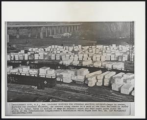 Jersey City, N.J. -- Cargo Destined For Overseas Awaiting Shipment -- Cargo in crates, destined for overseas shipment, is stacked along tracks in a yard of the Erie Railroad in Jersey City, N.J. today. Scene is typical of many at Atlantic coast and Gulf coast ports science the strike of the International Longshoremen's Association which began last Dec. 23.