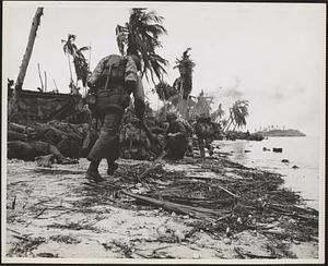 U.S. Marines invading Guam, hug the 'deck' on the beach