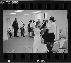 People wait at a government office, probably for civil wedding ceremonies