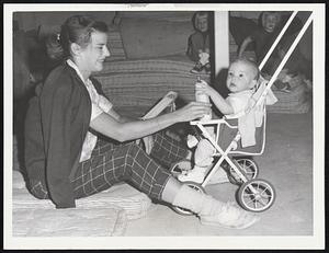 Fred Hoffmann III, 8 months, waits out hurricane Esther with his mother, Mrs. Fred Hoffmann of Flushing, N.Y. in Ezra Baker School, West Dennis.