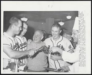 Milwaukee – Hungry Braves Celebrate Pennant Tie – Food occupies Milwaukee Braves in dressing room today after 5-2 victory over Phils gave the team tie in pennant race. From left, Ed Mathews, winning pitcher Bob Buhl, club owner Lou Perini, Don McMahon, who relieved Buhl, and chef.