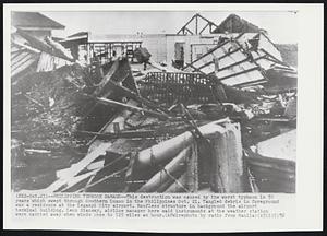 Philippine Typhoon Damage--This destruction was caused by the worst typhoon in 50 years which swept through Southern Luzon in the Philippines Oct. 21. Tangled debris in foreground was a residence at the Legaspi City airport. Roofless structure in background the airport terminal building. Leon Riansay, airline manager here said instruments at the weather station were carried away when winds rose to 125 miles an hour.
