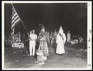The Ku Klux Klan revives, after 10 years silence at Stone Mountain its birthplace. High officials are shown in the foreground. They initiated 50 while visiting Klaverns from 28 states looked on.
