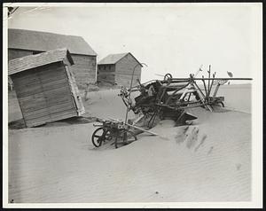 No Use To Dig It Out. Estevan, Saskatchewan, Canada -- Having long abandoned hope raising a wheat crop this year the owned has no reason to dig out his bonder, half covered with drifting sand and top soil. Drought conditions in this "bread basket" section and elsewhere in Canada have cut the wheat crop seriously and caused prices in America to advance.