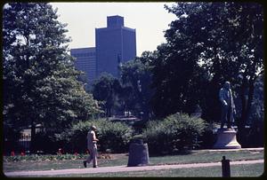 A person walking near Edward Everett Hale monument, Boston Public Garden