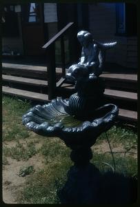 Water fountain with sculpture of child riding a fish