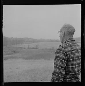 Albert Elwell looking out at a field at Maple Crest Farm