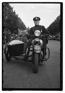 A police officer on a motorcycle with a sidecar