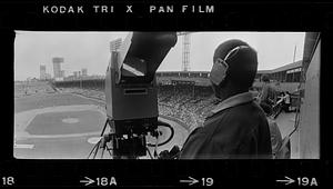 TV cameraman covers baseball game at Fenway Park, Boston