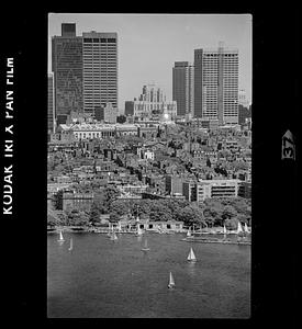 Sailboats on Charles River Basin with Beacon Hill in background, downtown Boston