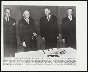 After Historic Signing--Signatories stand together in the upper house of the West German parliament at Bonn, Germany, today after linking the West German Republic with the Free World. From left are: Britain's Foreign Secretary Anthony Eden, France's Foreign Minister Robert Schuman, U.S. Secretary of State Dean Acheson and West German Chancellor Konrad Adenauer. The contract rests on table in front of them.