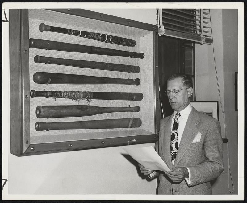 Famous Bats at the National Baseball of Fame and Museum at Cooperstown include the one at the bottom of the case used by Abner Doubleday in 1839. Museum Director Sid C. Keener checks the list.