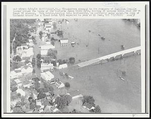 Scottsville, Va.: Floodwaters spawned by the remnants of Hurricane Camille lashed across the banks of the historic James River 8/20, leaving 38 persons known dead and at least 32 missing. This bridge, leading to Scottsville, is partially under water. The city of Richmond braced for a flood crest 8/21 expected to peak at 40 feet.