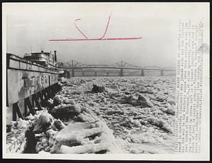 Public Wharf Blocked by Ice -- The public wharf in downtown Cincinnati was jammed with ice and blocked all the way to the Kentucky shore late this morning when jam that broke at New Richmond, 0., 25 miles up-river, stopped flowing and piled up here. Left is a cement loading dock and in front of dock is packet steamer "Gordon C. Greene." Bridges shown are L.&N,. most distant from camera, and Central bridge, both leading to Newport. KY.