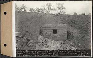 Contract No. 80, High Level Distribution Reservoir, Weston, looking northwest from Sta. 97+67+/- showing stone headwall for culvert through dam 5, high level distribution reservoir, Weston, Mass., Jul. 2, 1940