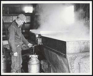 Milton Fullerton - Top Acres - South Woodstock, Vt, draws off some newly made maple syrup from the evaporator. - 90 gallons of sap run through the evaporator, each hour. It takes 40 gallons of sap to make 1 gallon of maple syrup.