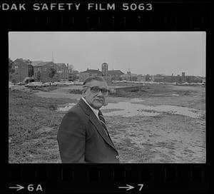 Peter Matthews next to flooded vacant lot