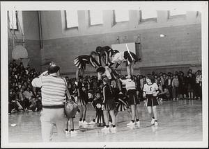 Cambridge Rindge and Latin School (CRLS) cheerleaders at a basketball game