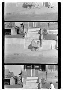 A child next to baby carriage in front of steps, Maude Sanromá on right