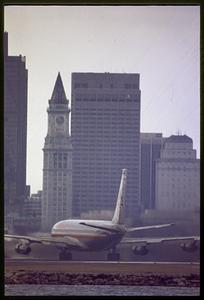 Arriving jetliner at Logan Airport and downtown skyline, East Boston