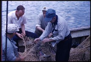 Fisherman mending nets