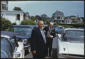 Two men standing among parked cars, Swampscott, Massachusetts