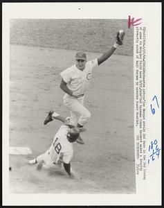 Houston Astos' Joe Morgan steals 2nd base in the 3rd inning of game in Wrigley Field here 5/19. Cubs' 2nd baseman Glenn Beckert makes a leaping glove-tip catch of ball thrown by catcher Randy Hundley.