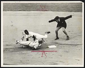 Boston Red Sox fielder makes a play on Chicago White Sox runner at second base as umpire makes safe sign