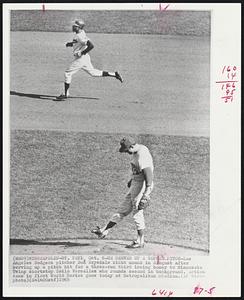 He Served Up A Gopher Pitch - Los Angeles Dodgers pitcher Don Drysdale kicks mound in disgust after serving up a pitch hit for a three-run third inning homer to Minnesota Twins shortstop Zoilo Versalles who rounds second in background. Action came in first World Series game today at Metropolitan Stadium.
