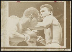 Zora Folley, left, moves in on champion Cassius Clay in first round of their heavyweight title fight in New York's Madison Square Garden tonight.
