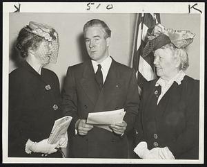 Surrounded!-The harassed looking gentleman is Mayor John E. Kerrigan. The V-K Day smiles (would that be for "Victory over Kerrigan"?) are worn by Mrs. Joseph Leonard (right) who has just unburdened her feelings about the 1945 city cleanup drive she headed, and her silent partner in a conference with the mayor today, Ellen Gleason of the Boston recreation commission.