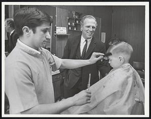 Mayor White Visiting Tommy's Barber Shop on Broadway in S. Boston. While Bob Ciulla is giving Bobby Cvilikas a haircut.