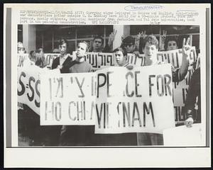 Carrying signs lettered in Hebrew and English, anti-Vietnam war demonstrators gather outside U. S. Embassy here 10/15 for a 90-minute protest. Some 200 persons, mostly students, including Americans from Jerusalem and Tel Aviv universities, took part in the peaceful demonstration.