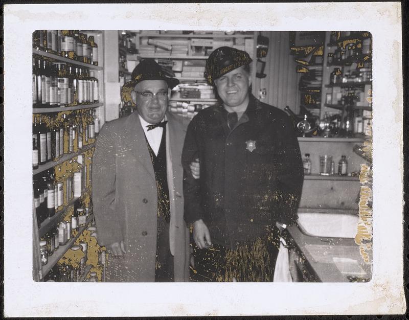 William C. Moulton and a police officer, in Moulton's drugstore