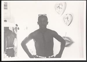 Young man posing in front of a mirror