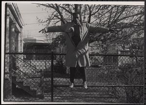 Young man balancing on a fence