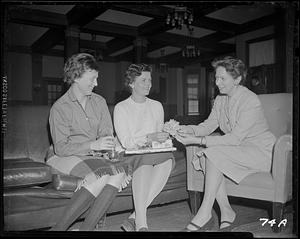 Three women looking at card