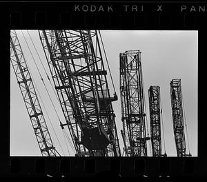 Folded construction cranes in storage yard, Everett