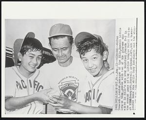 Winners - Nobuo Yamauchi, center, manager of the Hilo, Hawaii Little League team, poses with two of his players who aided in Hilo’s win over Montreal, Canada 8-5 in the second game of the Little League World Series at Williamsport. Russell Arikawa,left,hit a bases-loaded home run while Gary Matsumoto was the winn-