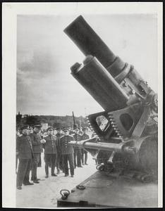 No Bark, No Bite--This huge German siege mortar, captured by the Russians on their western front, shown under inspection by high-ranking Red Army and Navy officers.