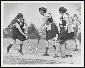 Fast Action on the Bouve-Boston hockey field is recorded by Traveler camera’s speedy shutter in above sequence. Natalie Harlow of Orange, Conn., (at left) has a close brush with opposing players as she scores a goal. Natalie knocks aside opponent’s stick (second photo) during mighty swing which sends ball past ankles of Goaltender Barbara Olnsky of Brighton (wearing heavy leg guards). All the girls in above photos are seniors planning to become physical education teachers in schools or community recreation centers. The school, which is affiliated with Tufts University, specializes in training girls for careers in physical education and physical therapy.