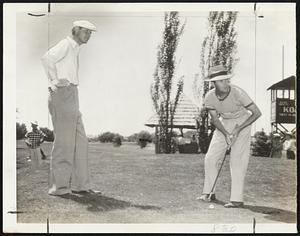 Watches his Foe Battle for ‘Life’-Horton Smith (left), who won his first two matches in the P.G.A. tournament at Denver yesterday, is shown here with his first victim, Paul Runyan, on the eight green.