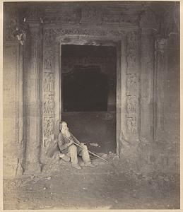 Doorway of Buddhist Vihara, Cave XXIV, Ajanta, with Major Gill seated in entry
