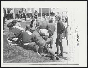 Injured--A Kent State University lies on the ground after National Guardsmen fired into a crowd of demonstrators here today. Four persons were reported dead and 11 wounded.