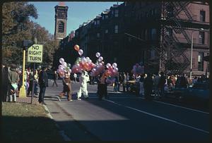 People holding balloons, some wearing costumes, Old South Church in background, Boston Columbus Day Parade 1973