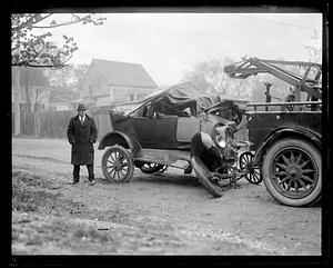 Damaged car behind a tow truck