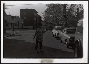 A woman standing in the middle of the street