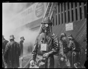 Fireman Arthur Thompkinson of Ladder 1, Chelsea, working in thick smoke at a two alarm rag shop fire
