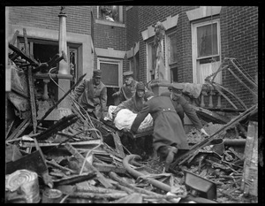 Taking out a body in the general alarm fire in Lynn. An apartment house where five died.